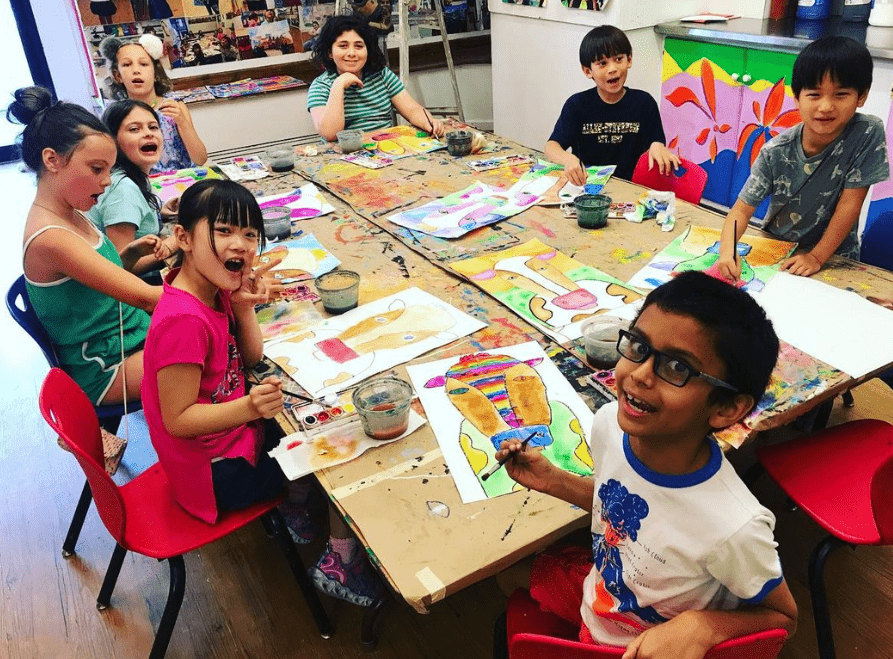 kids around the table at a painting workshop