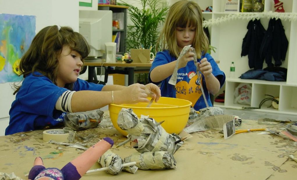 kids making papier mache artwork