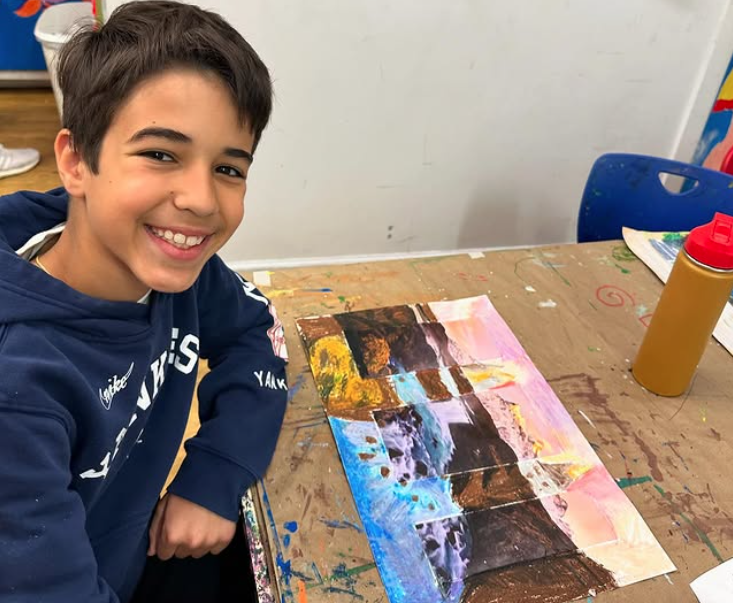 smiling young artist showing off his drawing collage combo art